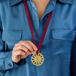 Lalaounis gold pendant with red band.