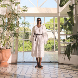 White Marina Rinaldi dress worn with a black belt.