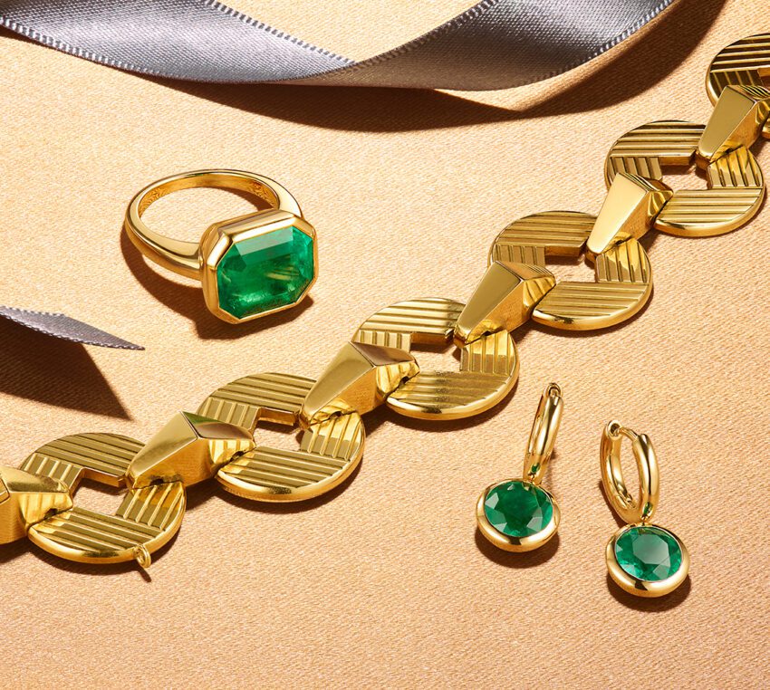 Fred Leighton gold necklace and gold & emerald ring and earrings.
