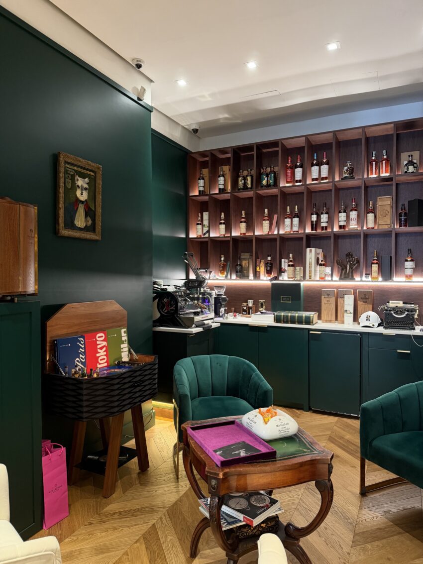Interior of Collezione New York boutique showing seating and bottles of spirits.