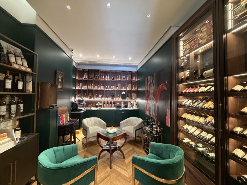 Interior of Collezione New York boutique showing seating and bottles of spirits.