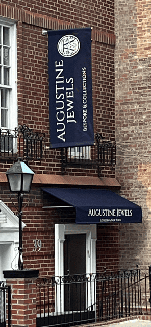 Augustine Jewels sign on brick facade