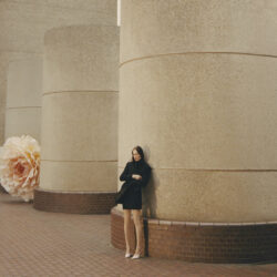 model holding Jimmy Choo handbag