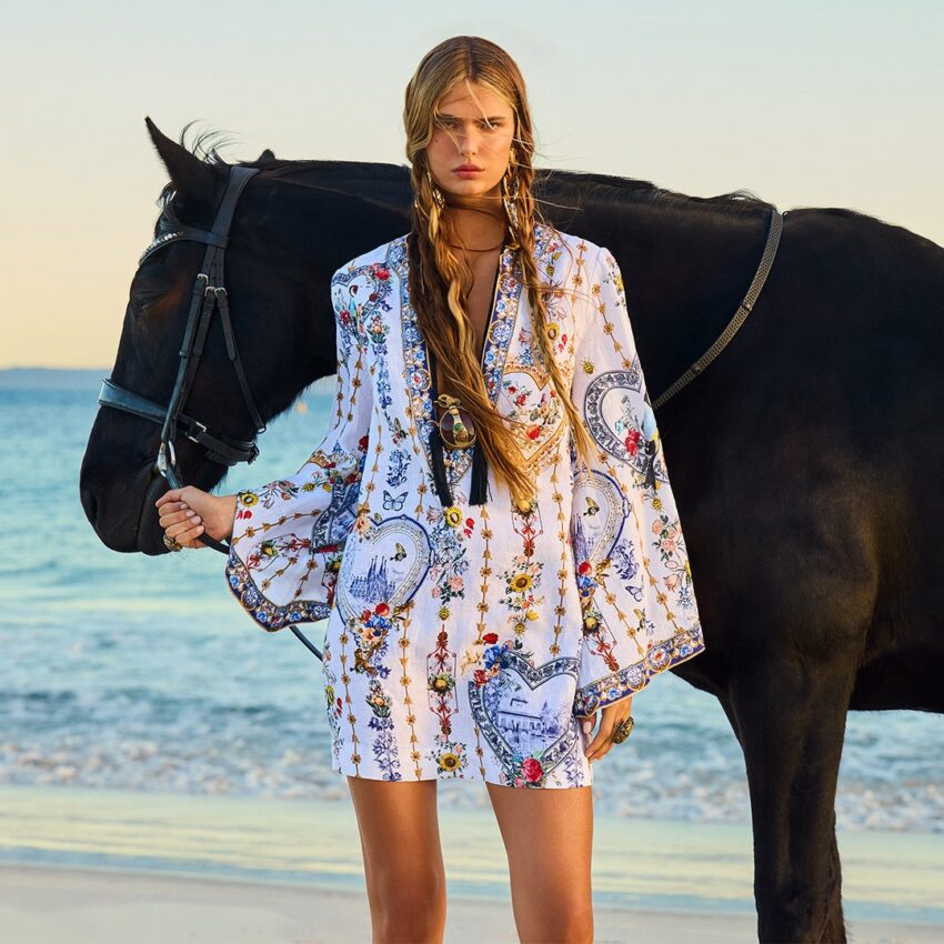 MODEL WEARING CAMILLA DRESS WITH HORSE