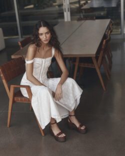Model sitting wearing paige white dress