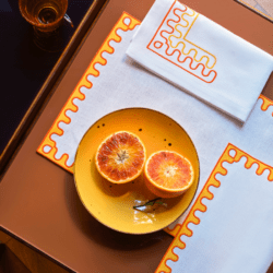 Orange on yellow plate and frette napkins