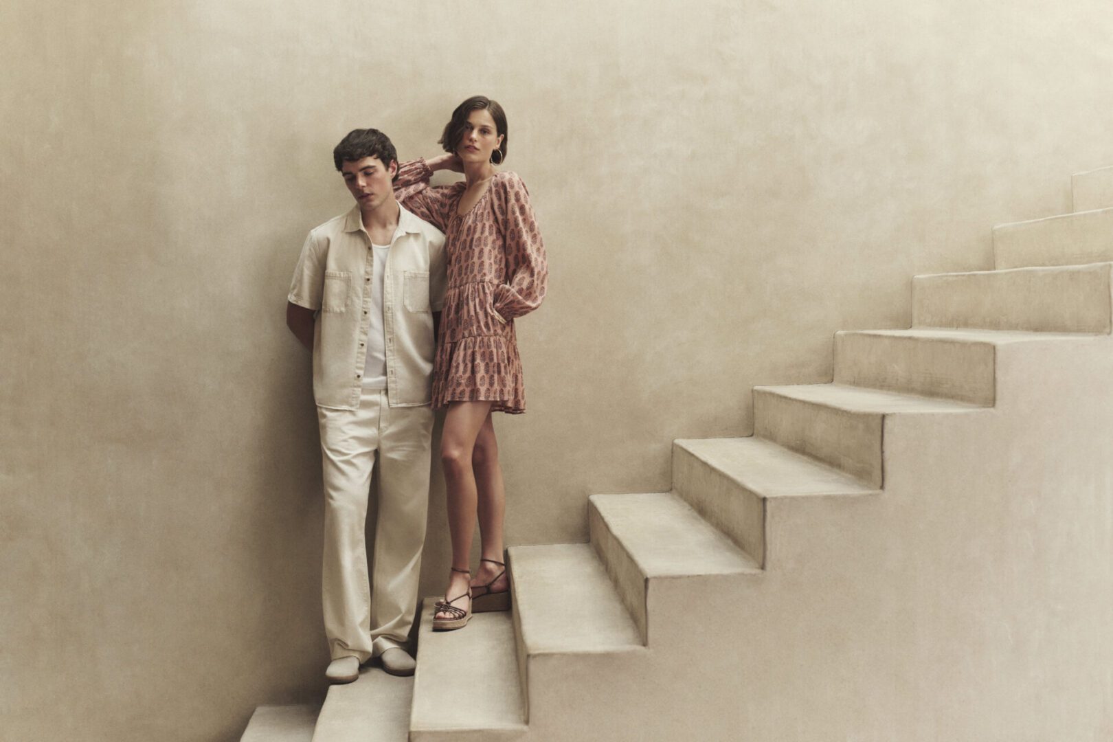 Man and Woman on stairs wearing Paige