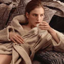 Model wearing Missoni robe drinking milk