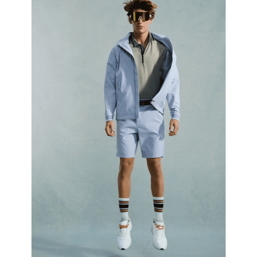 male model jumping wearing Bogner jacket and shorts