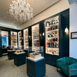 wall of liquor and chandelier at Collezione boutique