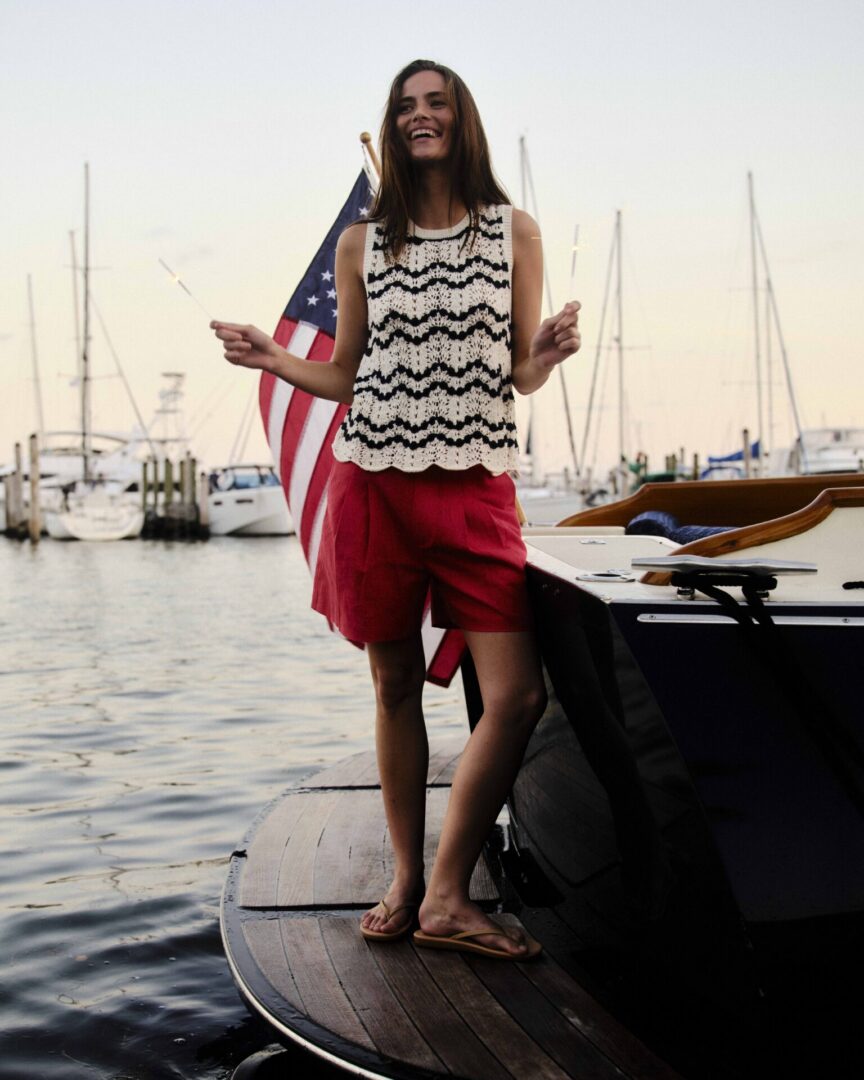 model on a boat wearing red shorts and striped from Cartolina