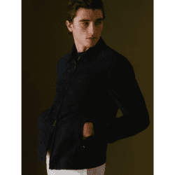 Model wearing Thom Sweeney brown jacket and white pants