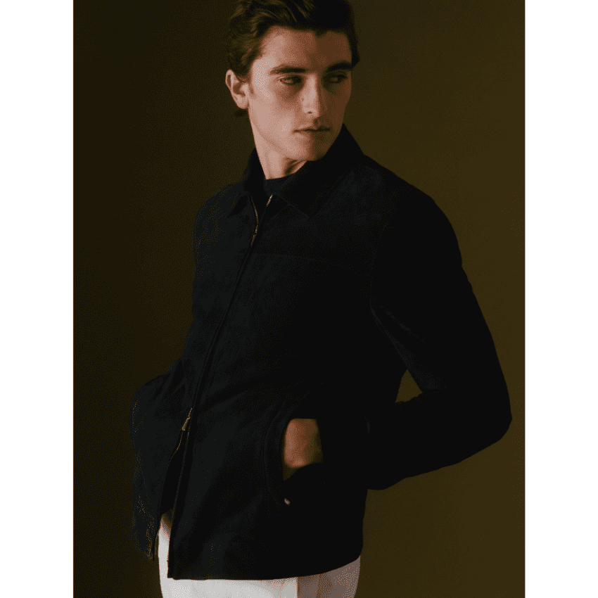 Model wearing Thom Sweeney brown jacket and white pants
