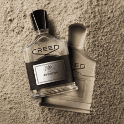 Creed fragrance bottle on sand