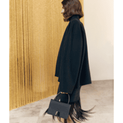 Model wearing black skirt suit and black fringe bag from Akris