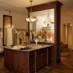 Inside Doen boutique Clothing hanging on racks and wood cabinets