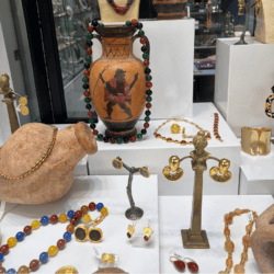 Jaded Madison avenue window with jewelry and vases
