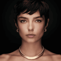 Woman modeling Paul Morelli's Gallant Collection gold necklace & earrings.