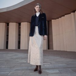 model wearing Peserico black jacket and white skirt