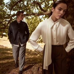 Female model weaing Vince white blouse Male model wearing Vince jacket and trousers