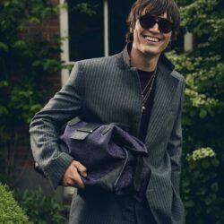 Alfie Nickerson in the British countryside wearing Jimmy Choo sunglasses and men's bag