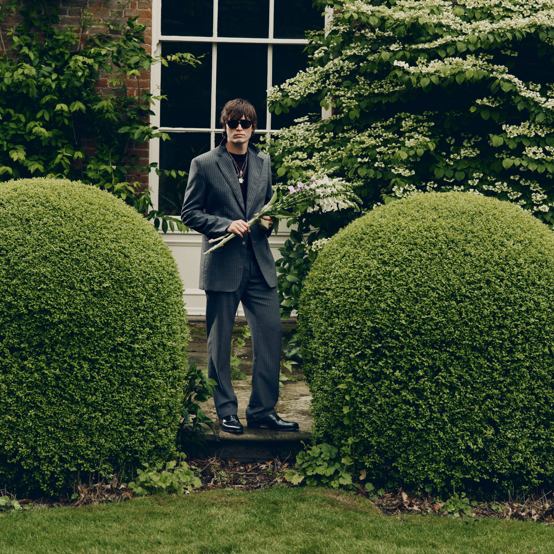 Alfie Nickerson in the British countryside wearing Jimmy Choo boots