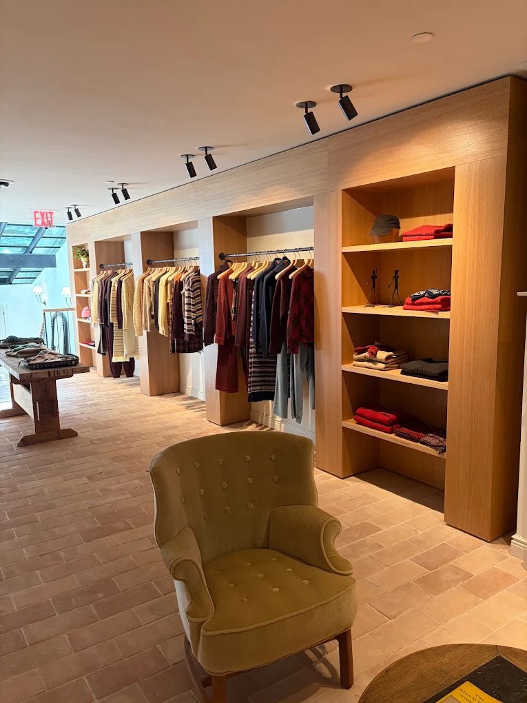 Arm chair and clothes hanging Inside Guest in Residence Madison Avenue store