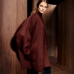 Model wearing burgundy Max Mara coat and skirt with turtelneck