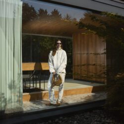 model wearing Manolo Blanik white pants and sweater with tan fluffy shoes and tan fluffy bag