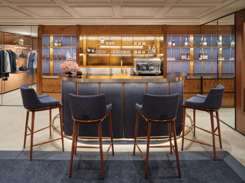 inside Jacob Cohen madison avenue store with bar and clothing displayed