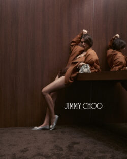 model wearing brown jacket with Jimmy Choo silver and pearl shoes and silver and pear bag