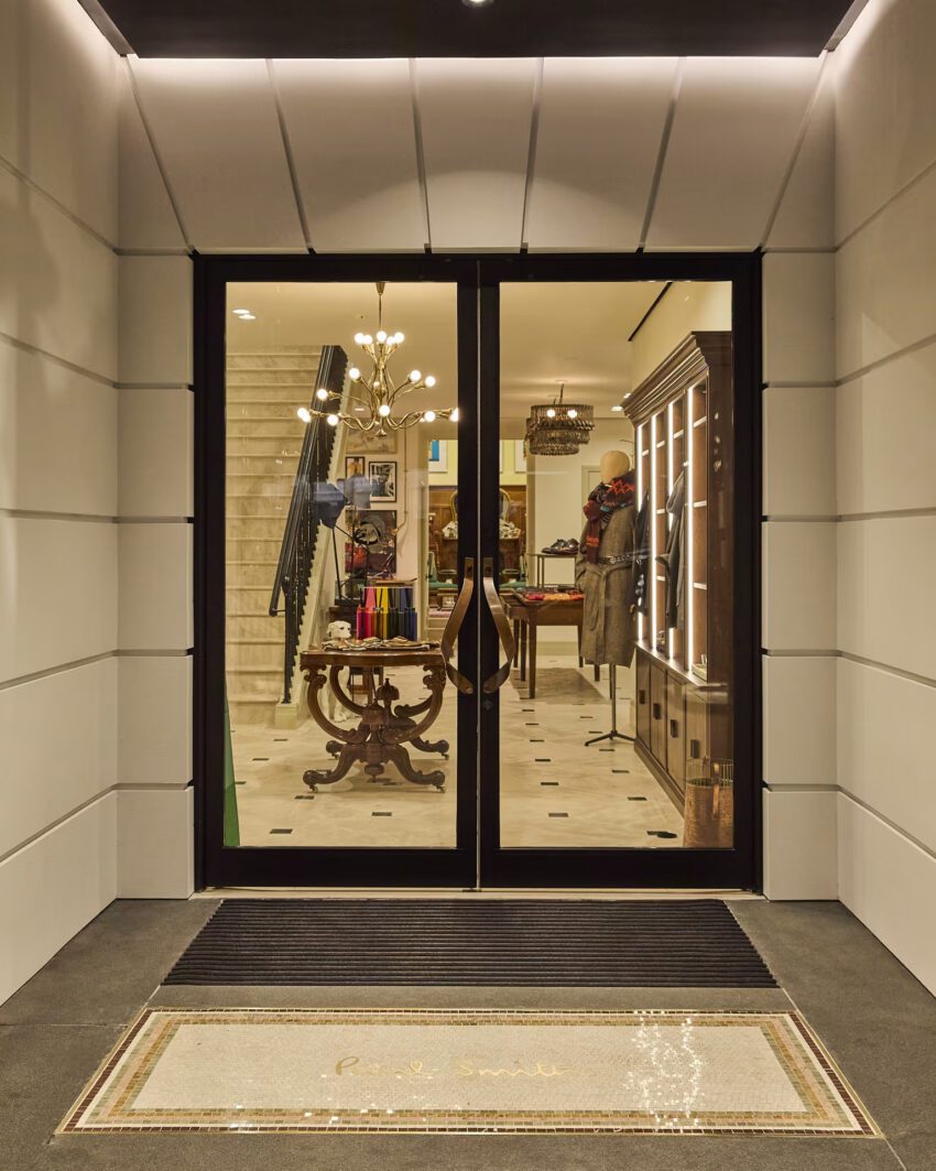 Entrance to Paul Smith madison Avenue boutique with glass doors and view of inside